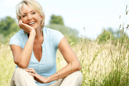 Woman sitting in a field.